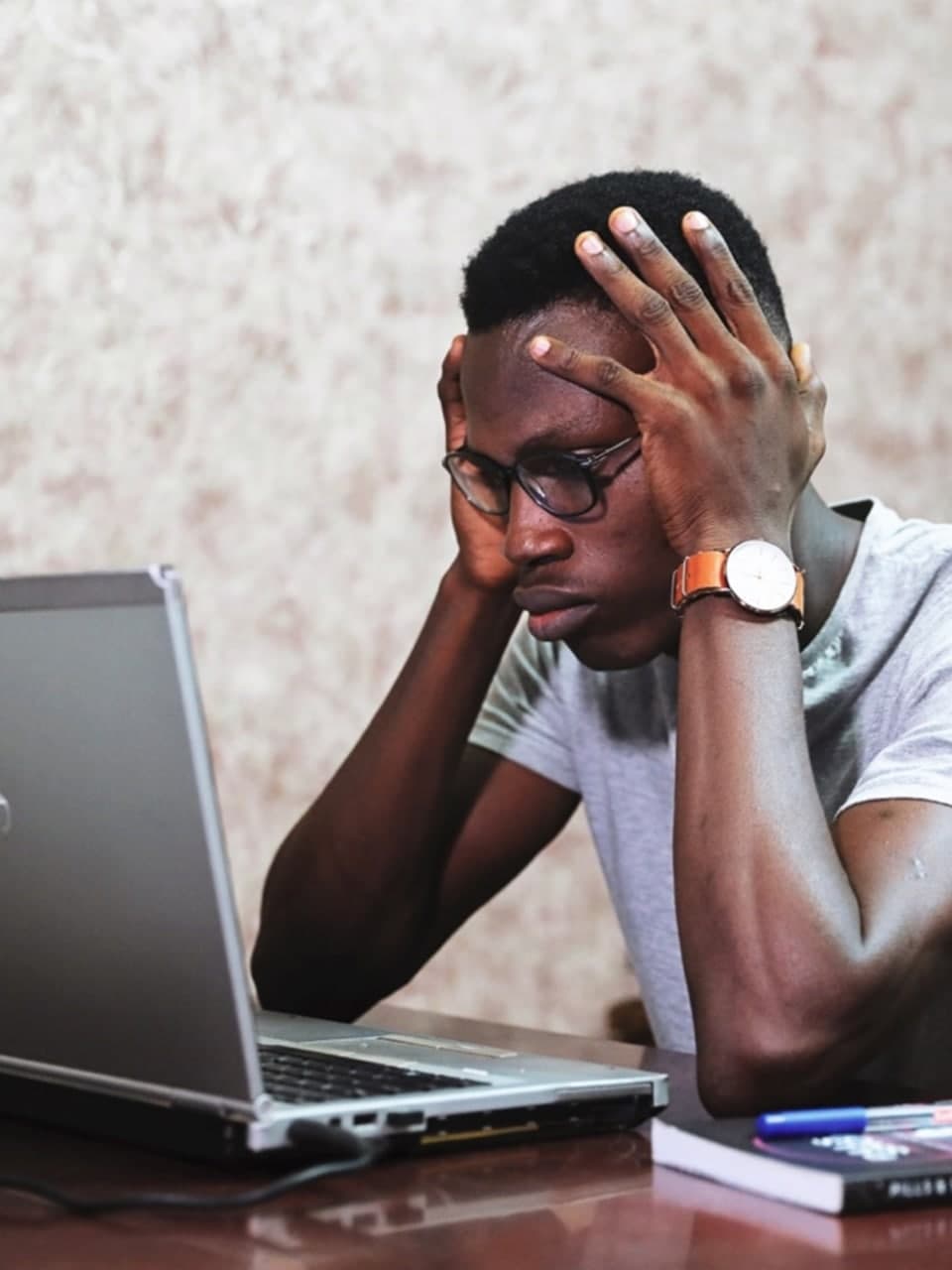 Depressed man watching laptop